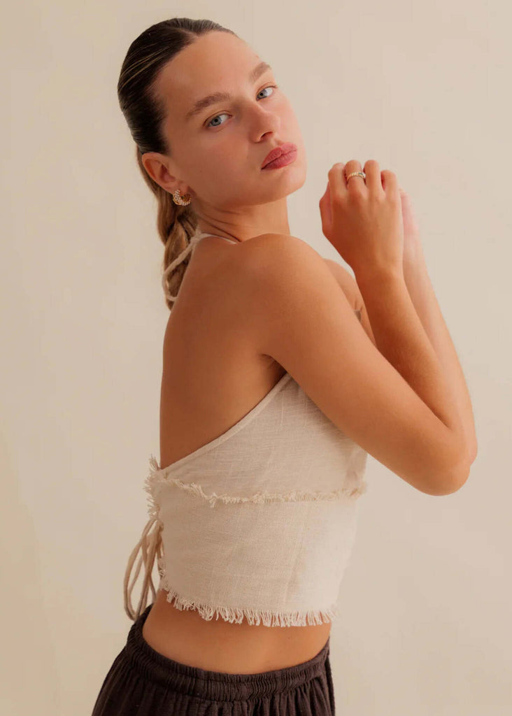 Amaya Top — Beige linen halter top with fringe, on model — MYFASHIONFRUIT