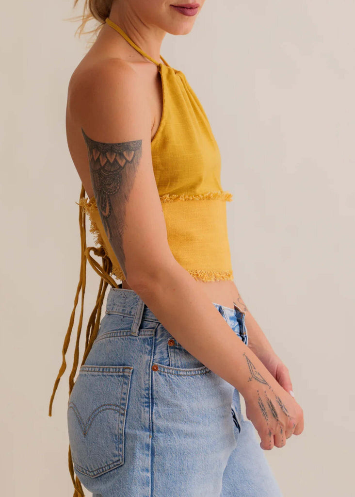 Amaya Top — Mustard yellow halter top, fringed hem, on model — MYFASHIONFRUIT