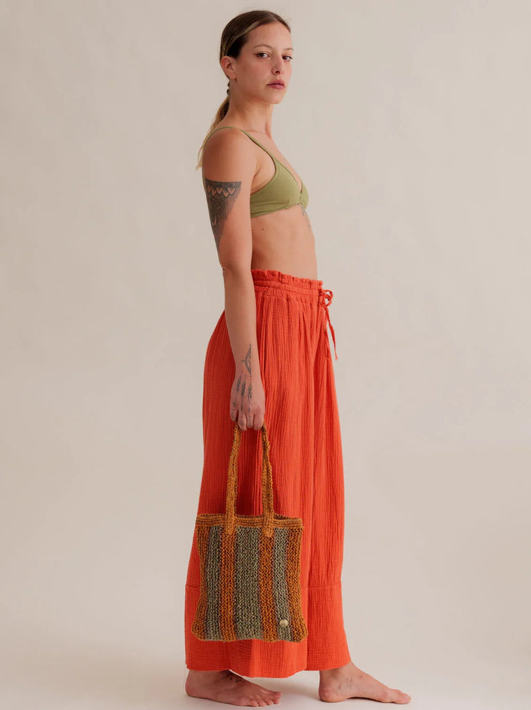 Crochet Striped Bag - Papaya & Green — bag on model with orange pants — MYFASHIONFRUIT
