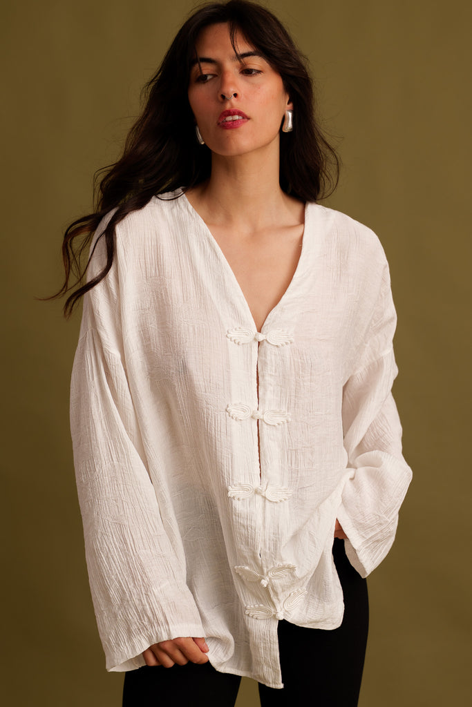 Soline Top — White textured top with butterfly clasps on model — MYFASHIONFRUIT