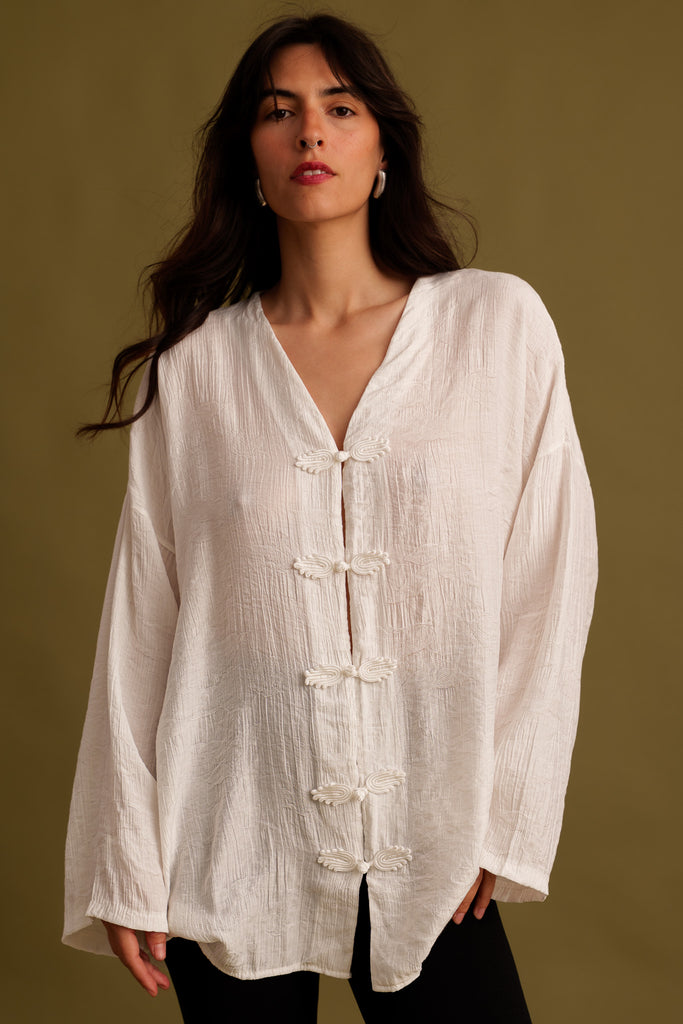Soline Top — White textured top with frog closures, on model — MYFASHIONFRUIT