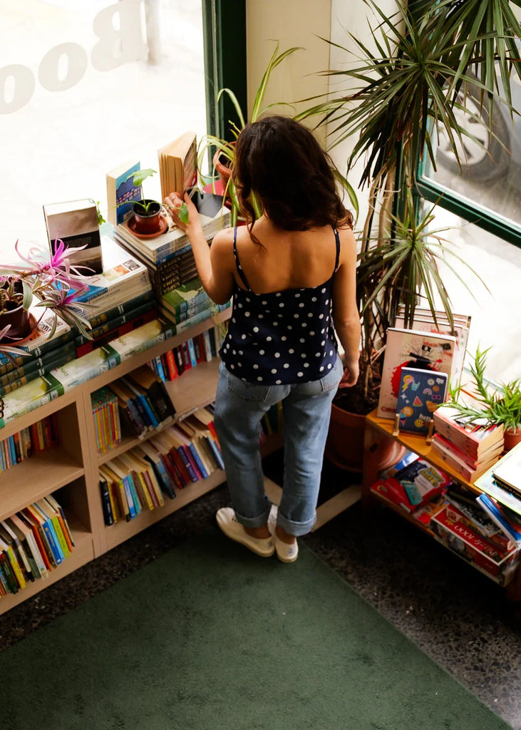 Betsy Top — Blue polka dot top on model in a bookstore — MYFASHIONFRUIT