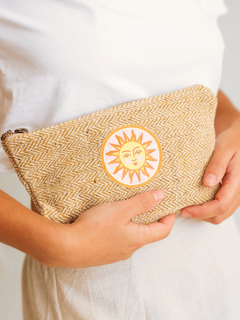 Sun Necessaire — woven pouch with sun design on model — MYFASHIONFRUIT