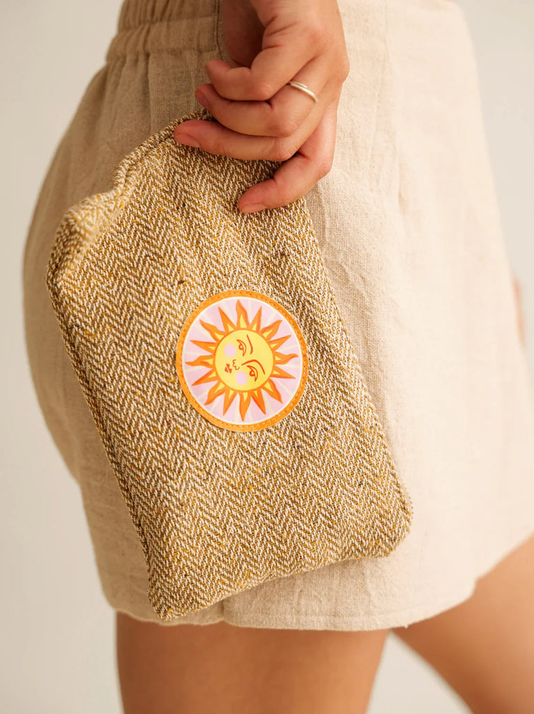 Sun Necessaire — Model holding woven pouch with sun patch detail — MYFASHIONFRUIT