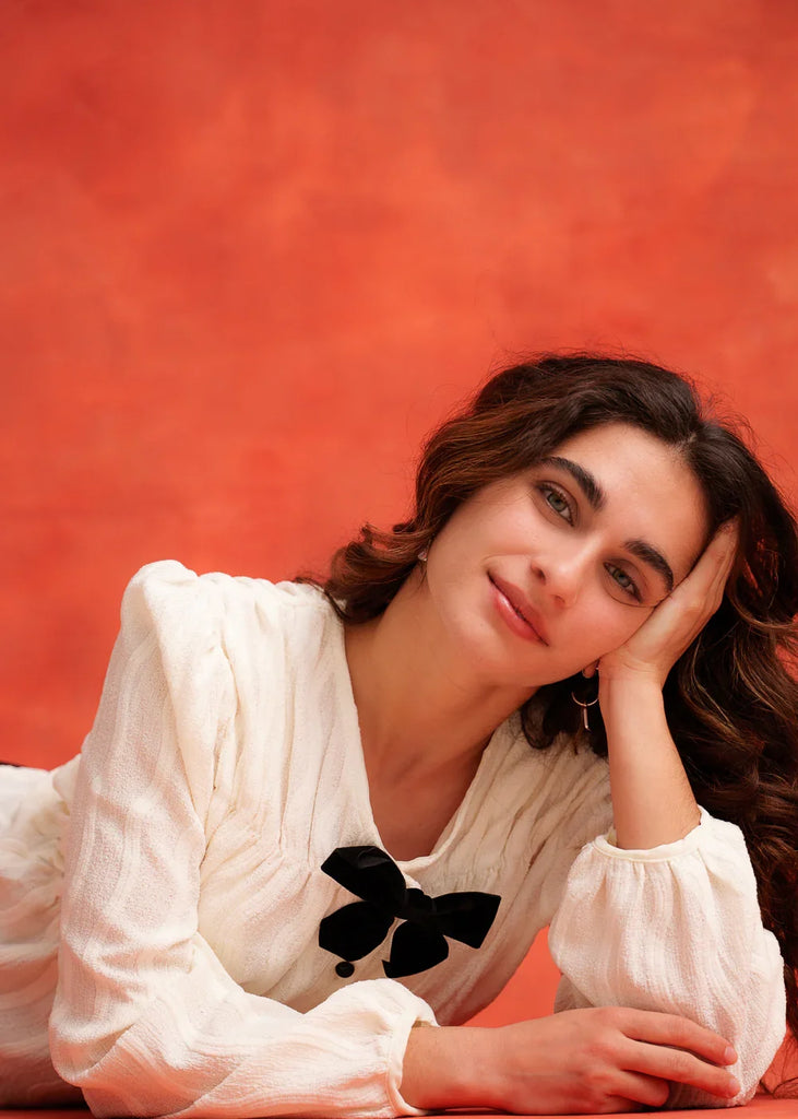 Mika Top — Model in textured cream top with black bow — MYFASHIONFRUIT