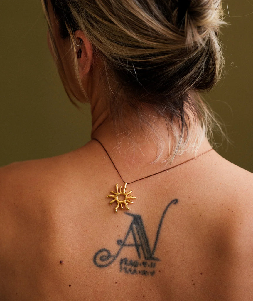 Sandya Pendant — Gold sun pendant on model, close-up — MYFASHIONFRUIT
