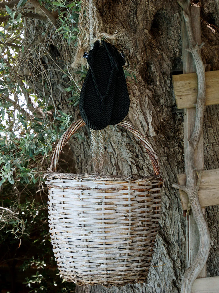 Flop Black Sandals — Sandals hanging above woven basket — MYFASHIONFRUIT