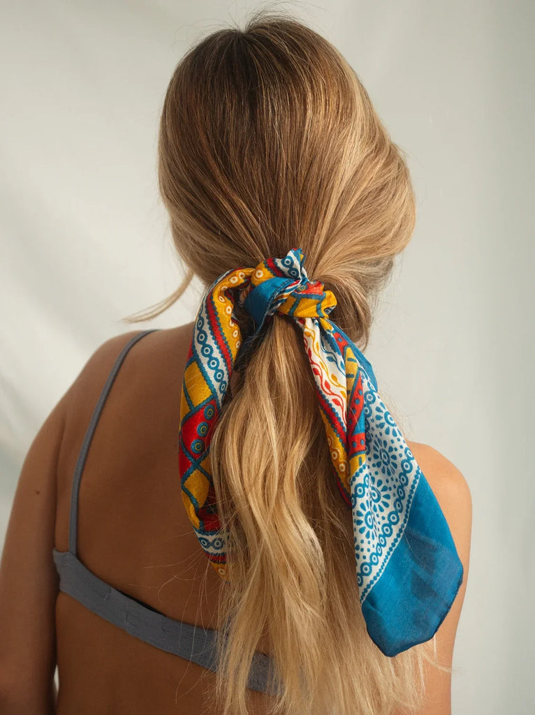 Woman wearing silk hair scarf in blue, yellow and red pattern — MYFASHIONFRUIT