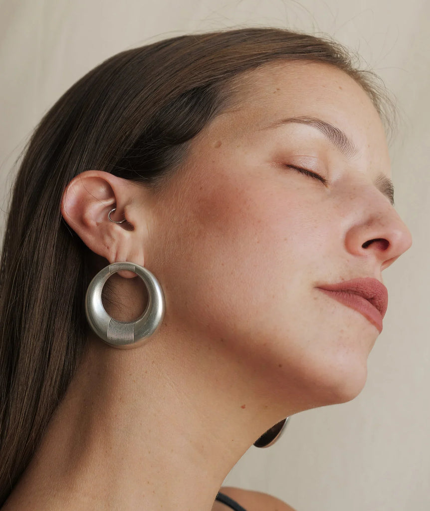 Woman wearing Aziza Hoops — silver earrings with engraved detail — MYFASHIONFRUIT
