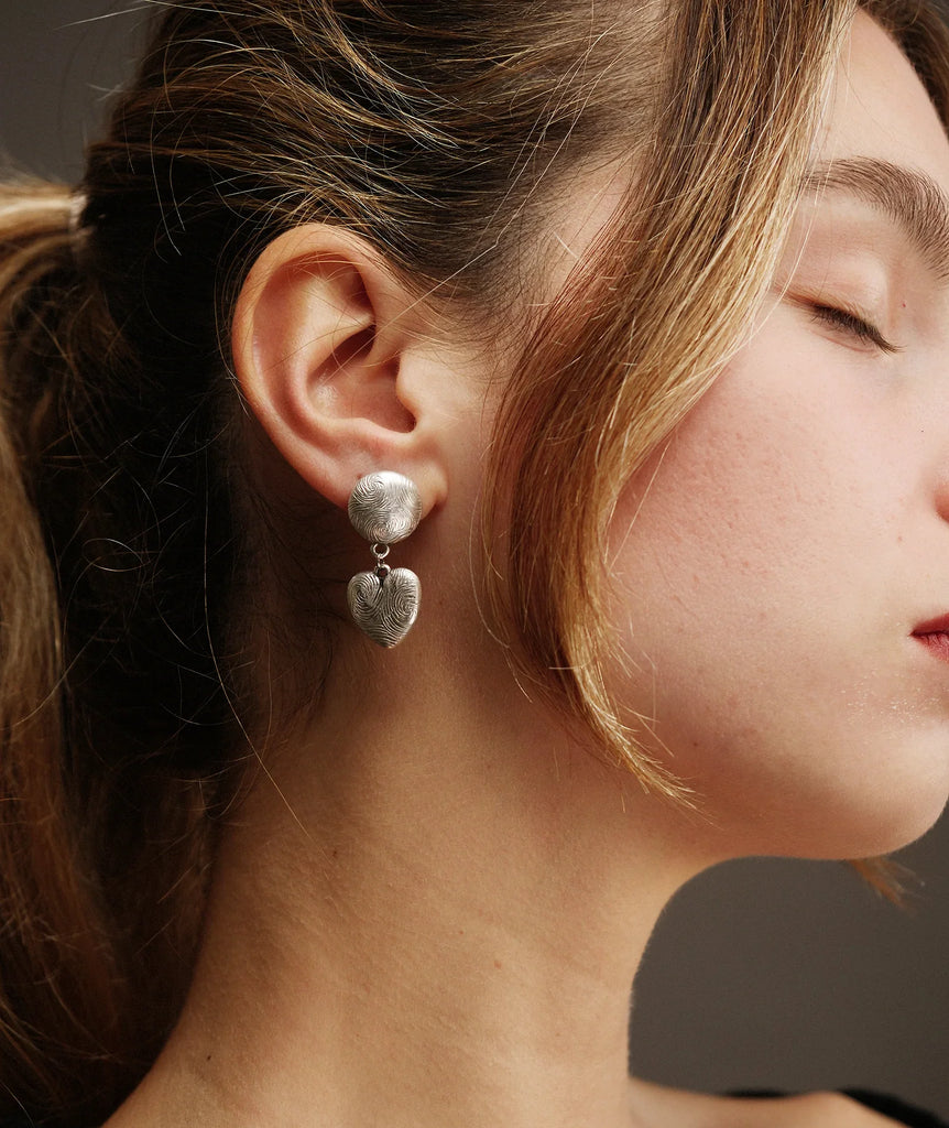 Woman wearing silver tone Esme Earrings with fingerprint pattern — MYFASHIONFRUIT