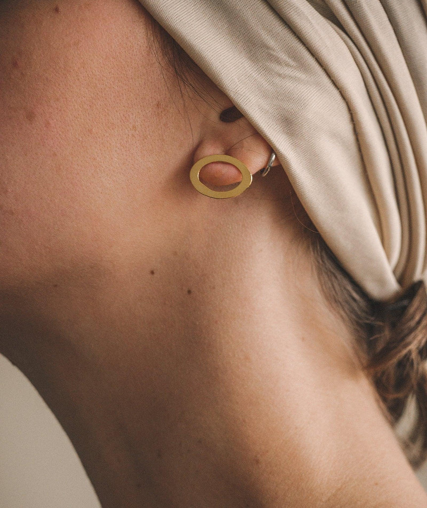 Woman wearing Ciclo Golden Earrings — gold oval shape — MYFASHIONFRUIT