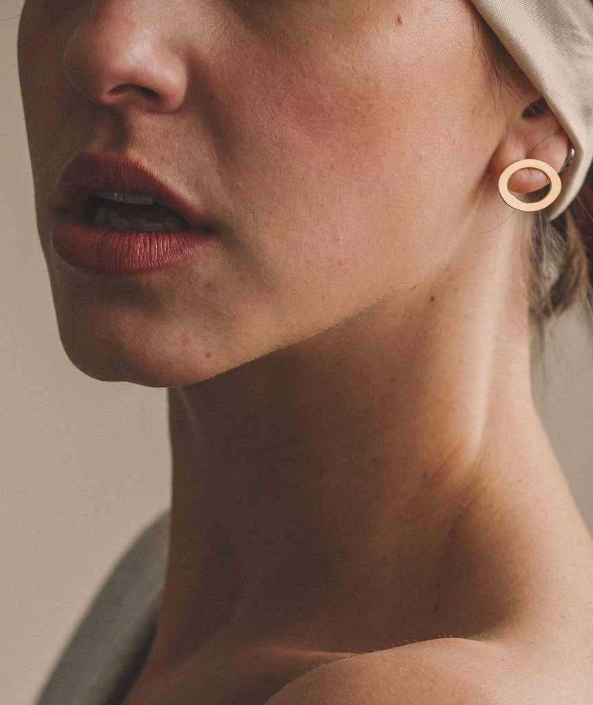 Ciclo Golden Earrings — gold oval stud on model — MYFASHIONFRUIT