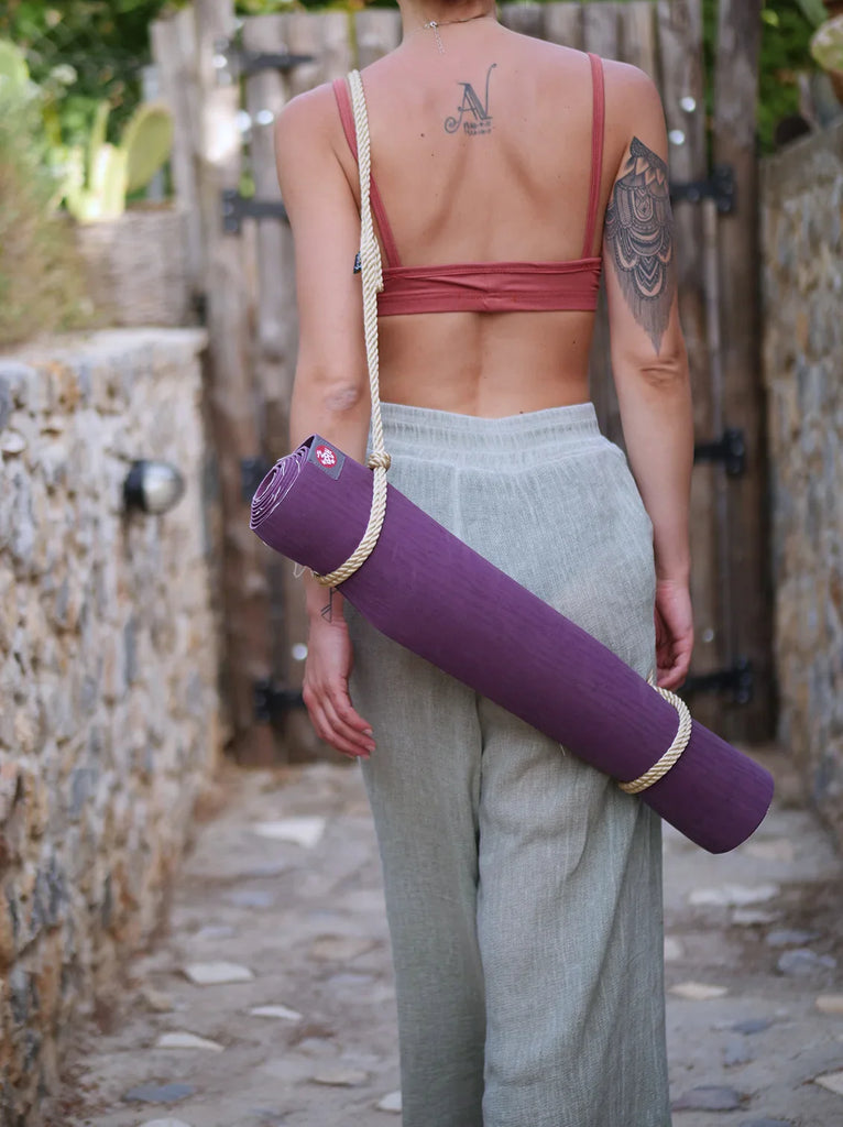 Woman carrying a purple yoga mat in Rope Yoga Mat Holder with rope strap — MYFASHIONFRUIT